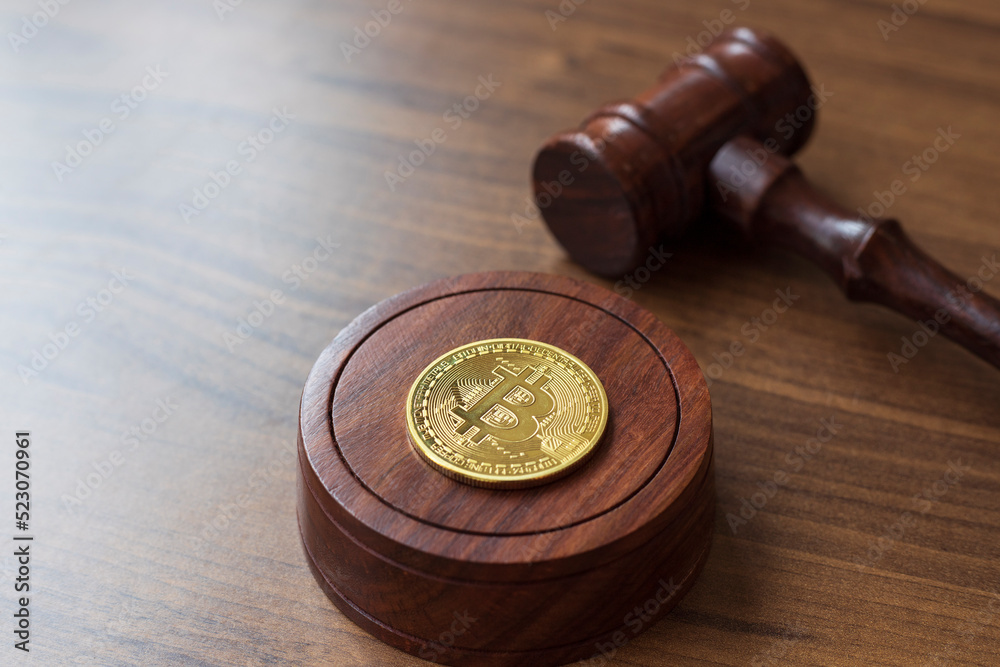  Judge gavel and bitcoin. Cryptocurrency legislation. Bitcoin ban. Violation of law