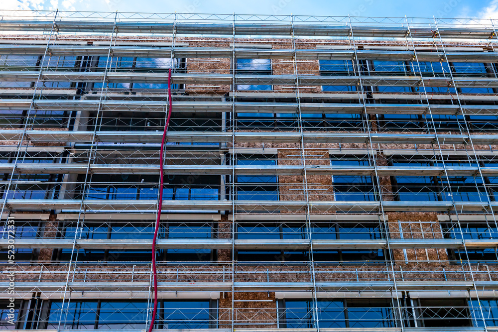 External wall insulation in progress. Scaffolding installed.