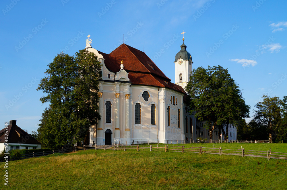 The Pilgrimage Church of Wies (German: Wieskirche) is an oval rococo church in the Bavarian Alps on a sunny day in August (Steingaden, Weilheim-Schongau district, Bavaria, Germany)