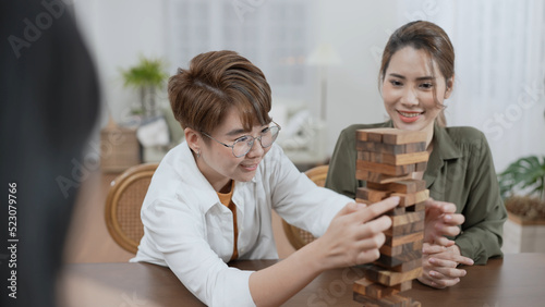 Holiday concept of 4k Resolution. Group of Asian female friends playing games together at home. Fun and exciting leisure activities.