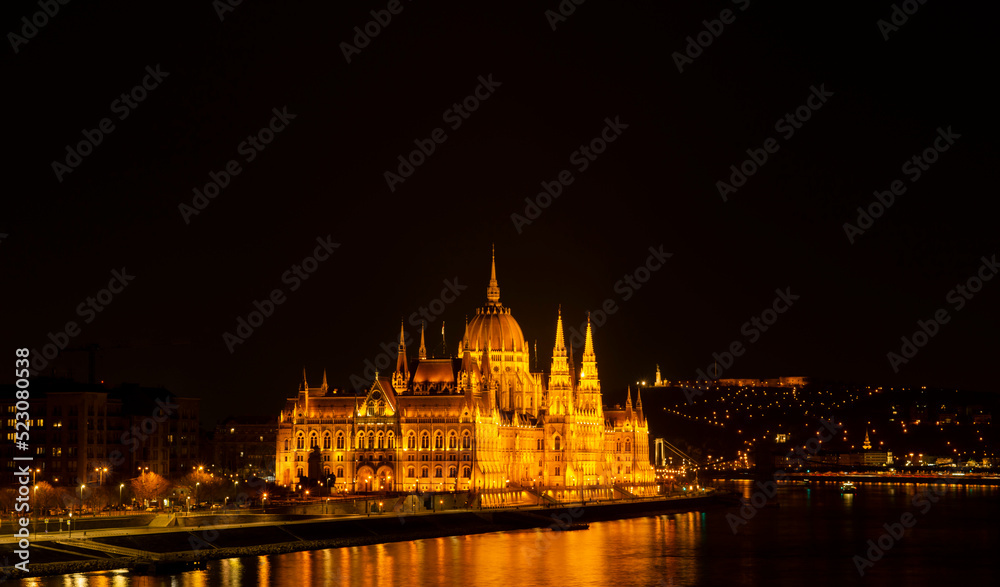 Fototapeta premium 20.03.2022 Budapest, Hungary. View to National Parliament on Danube River from Fisherman Bastion. Evening and night photo.