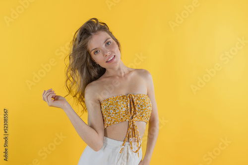 Portrait of young pretty girl smiling and feeling happy with long hair and no makeup on isolated background