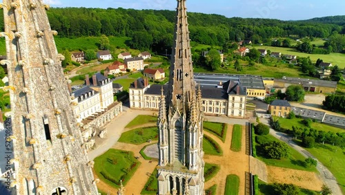 Aerial Backward Shot Of Notre Dame De Montligeon Church In Town - La Chapelle-Montligeon, France photo