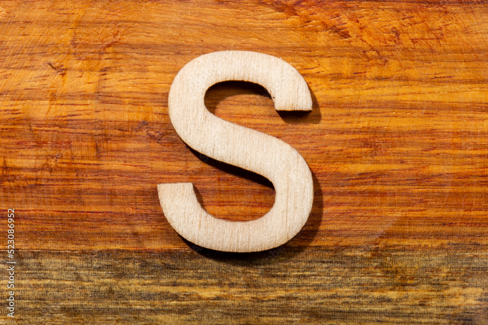 Wooden letters S on wooden background, top view Wooden letters S on wooden background, top view