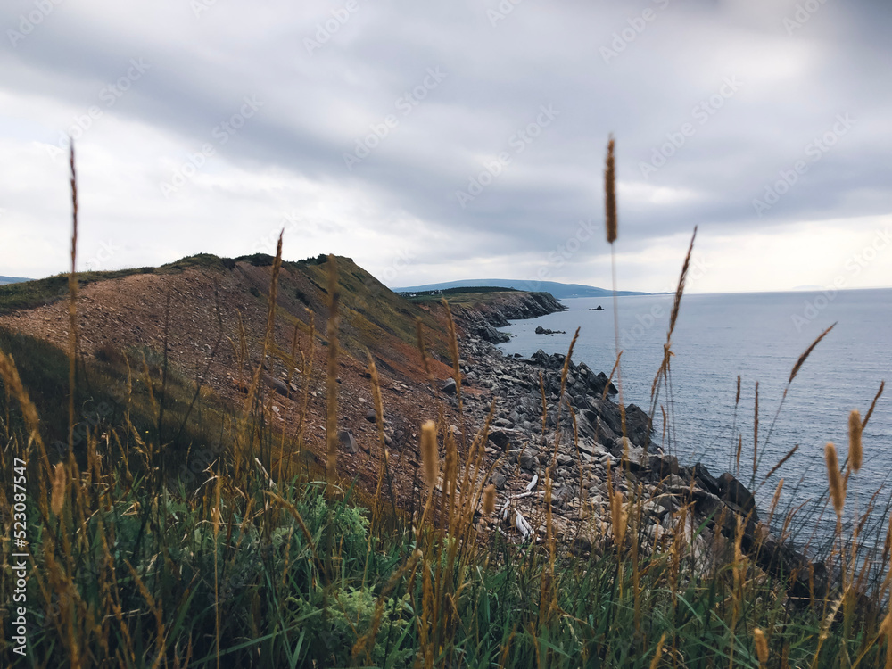 Ocean view and cliffs off Cape Breton, Nova Scotia. Cabot Trail visible in the background