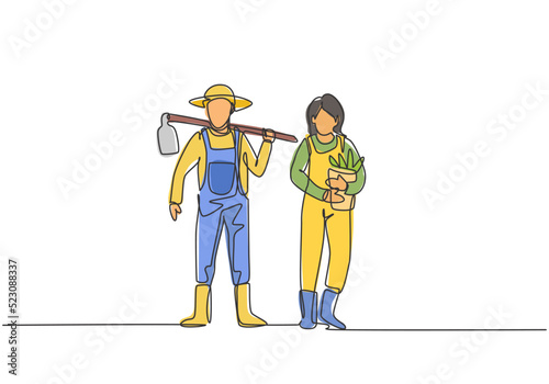 Single continuous line drawing young couple farmer shouldered hoes on his shoulders and carried buckets ready go to farm. Farming minimalism concept. One line draw graphic design vector illustration