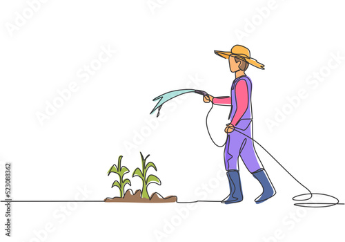 Single continuous line drawing young male farmer standing on farm field while watering the plants using a hose. Farmer planting activities concept. One line draw graphic design vector illustration.
