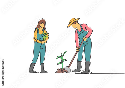 Single continuous line drawing young couple farmer shoveled the soil with the plants using a shovel. Planting new plants. Farming minimalism concept. One line draw graphic design vector illustration.