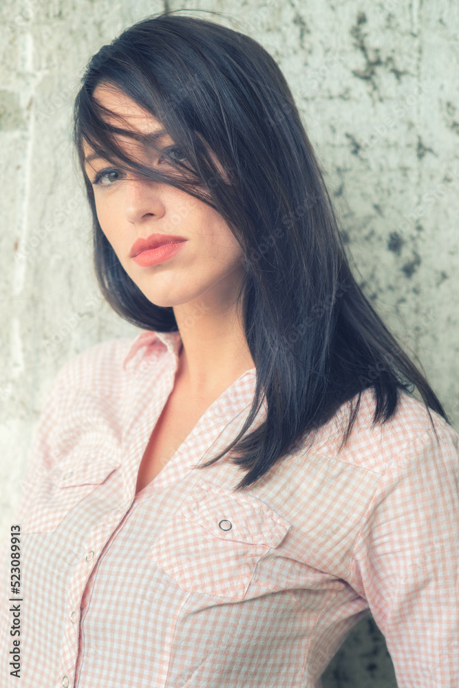 Portrait of beautiful young woman with green eyes and long brown hair