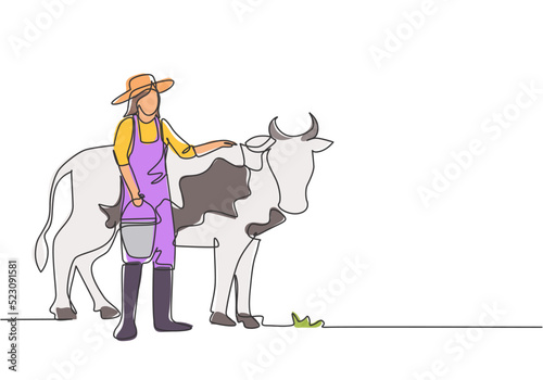 Single one line drawing of young female farmer rubbing the cow while carrying a bucket of water. Farming challenge minimal concept. Modern continuous line draw design graphic vector illustration.