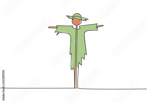 Single continuous line drawing of scarecrow installed by farmers to ward off pest birds which has damaged rice crops in the fields. Minimalism concept. One line draw graphic design vector illustration