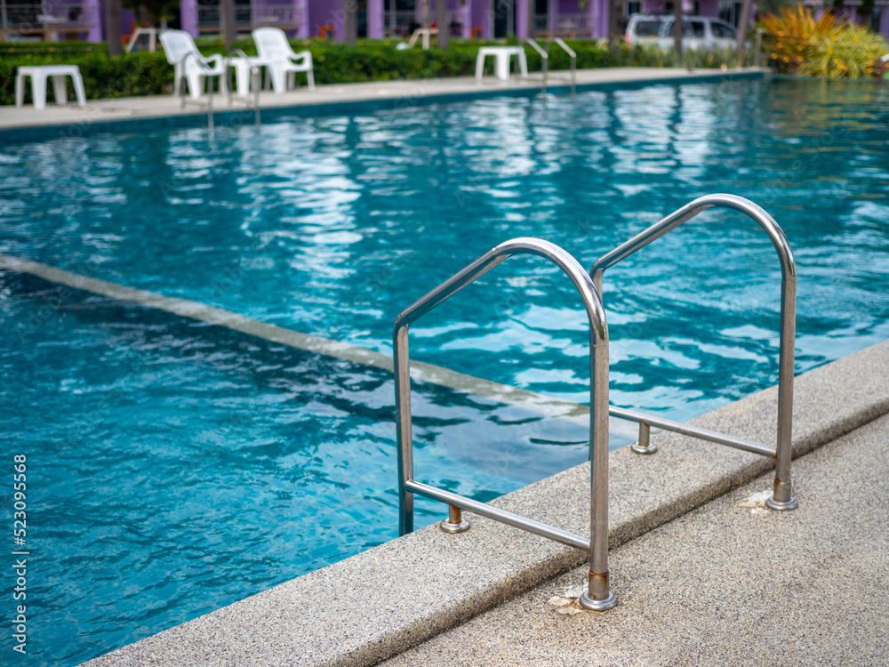 .Stainless steel stairs to the pool. handrails up and down the pool.