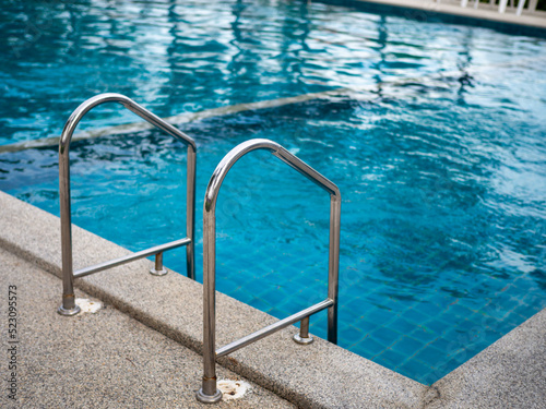 .Stainless steel stairs to the pool. handrails up and down the pool.