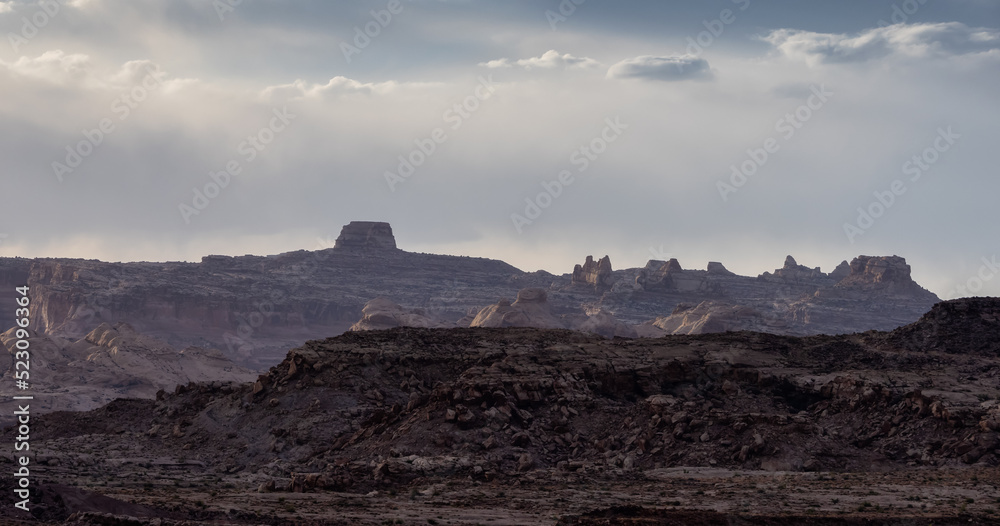Rugged Mountain Rock Formations in the desert with dramatic clouds at sunset. Utah, United States of America. Nature Background.