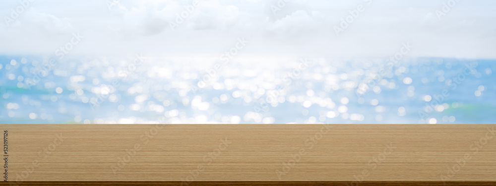 Empty Wood Table on Sea Summer Background.Blank desk with bokeh water ocean and blue sky Horizon Landscape Outdoor photo backdrop.Mockup Board for add Product Presentation.Tropical Nature Tourism.