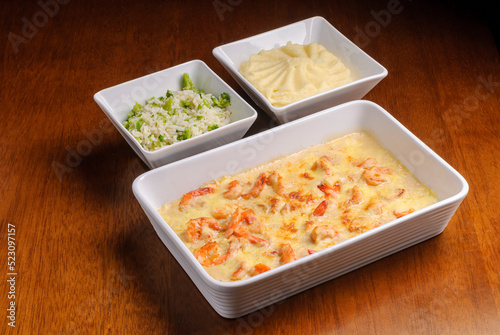 Shrimp with catupiry cheese accompanied by rice with broccoli and mashed potatoes. Brazilian seafood. photo