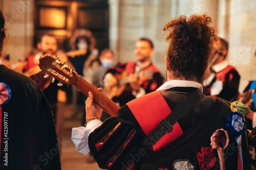  Tuna Music of Santiago - Band of University students musicians, dressed in academic costume, playing and singing serenades. on a Santiago de Compostela city street, Galicia, Spain photo