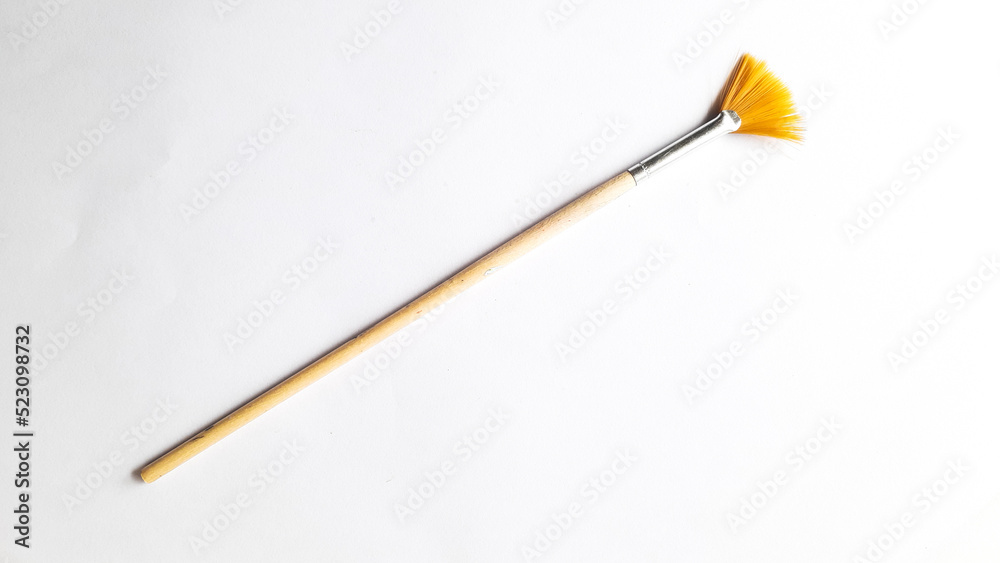 Top view of a variety of artist brushes on a white background with copy space for text. Creative postcard. Top view of a variety of artist brushes on a white background with copy space for text. Creative postcard.