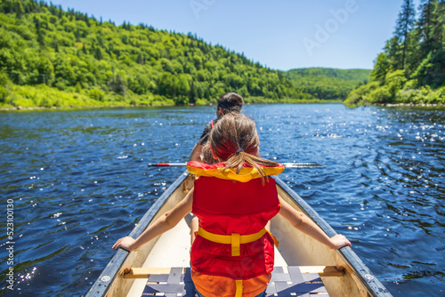 Children on a canoe on a river in a national park photo