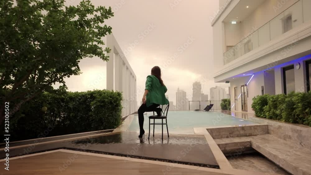 Dancer Posing And Stepping From Chair At Poolside Dancer Posing And Stepping From Chair At Poolside