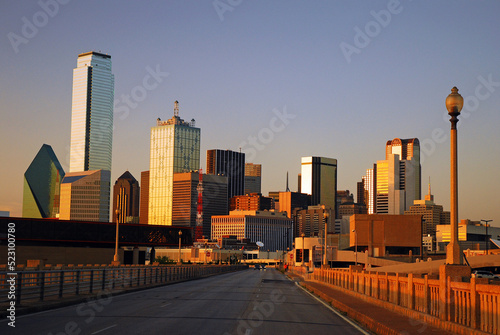 The Dallas Skyline towers over the Commerce Street Bridge and reflects the setting sun in the windows