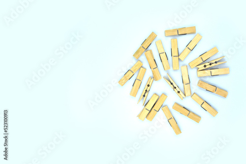 A clothes peg made of bamboo is placed on a white background.