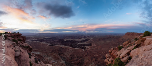 Scenic Panoramic View of American Landscape and Red Rock Mountains in Desert Canyon. Cloudy Sunrise Sky. Canyonlands National Park. Utah, United States. Nature Background Panorama