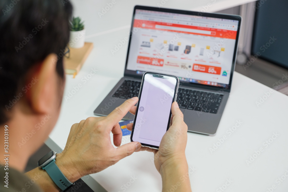 Man using smart phone and holding credit card with online shopping.Online payment concept. payment confirmation Man using smart phone and holding credit card with online shopping.Online payment concept. payment confirmation