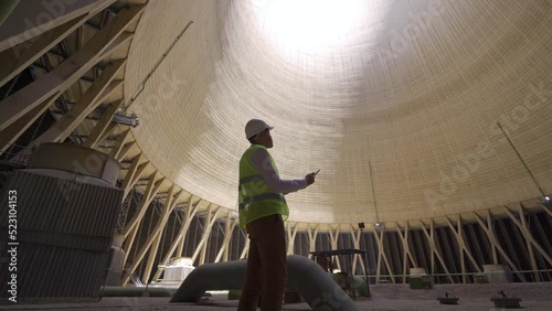 Natural gas processing plant.
Engineer working inside the cooling tower at the natural gas processing plant.
