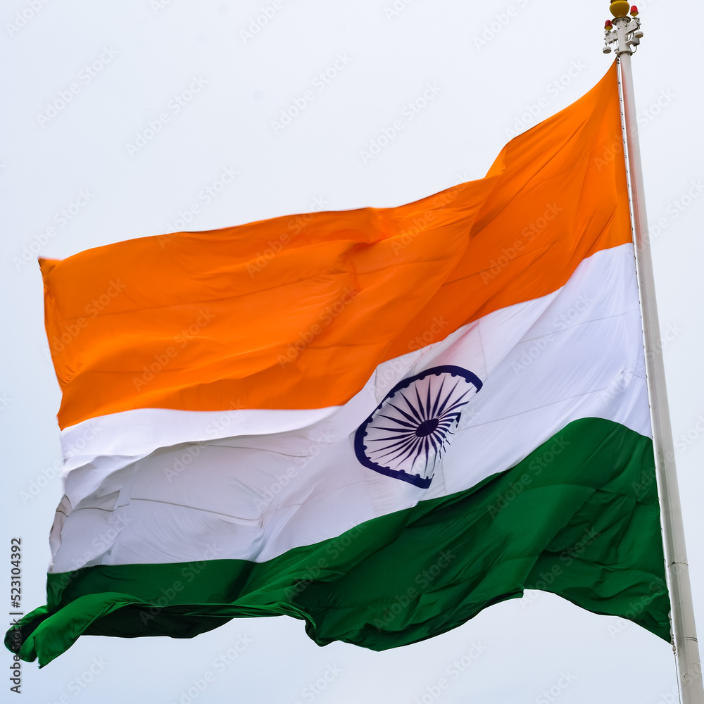 Plakat India flag flying high at Connaught Place with pride in blue sky