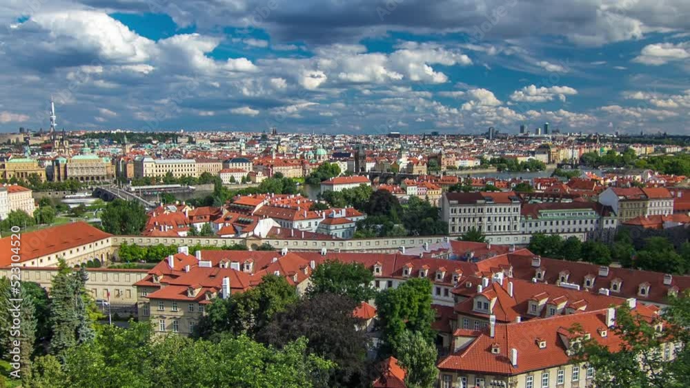 Panorama of Prague Old Town with red roofs and green trees timelapse, famous Charles bridge and Vltava river, Czech Republic. View from above near Prague castle Panorama of Prague Old Town with red roofs and green trees timelapse, famous Charles bridge and Vltava river, Czech Republic. View from above near Prague castle