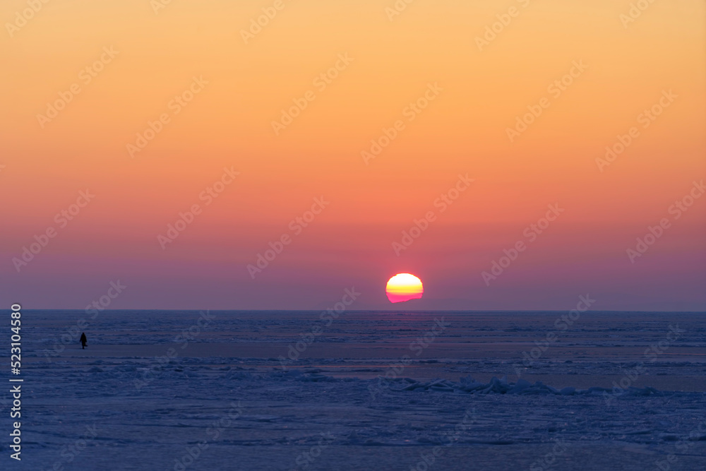 Natural backdrop with sunset over the frozen sea