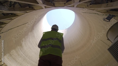 Petrochemical plant.
Engineer working inside cooling tower at petrochemical plant.
