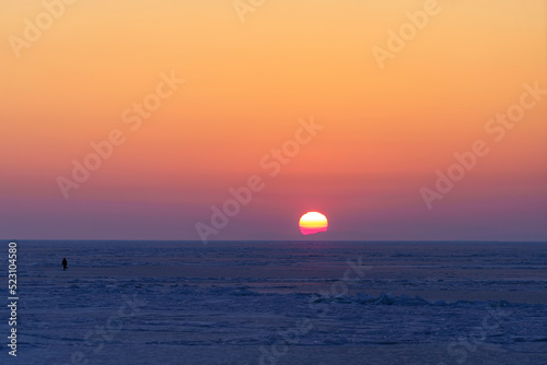 Natural backdrop with sunset over the frozen sea