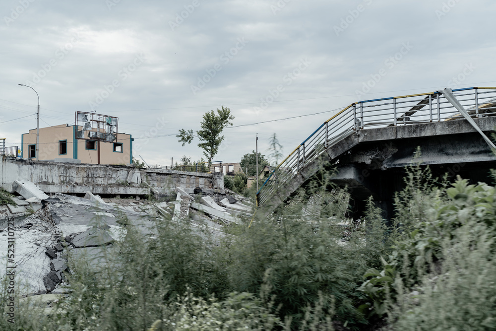 IRPIN, UKRAINE - July 18, 2022: War in Ukraine. People cross a destroyed bridge as they evacuate the city of Irpin, northwest of Kyiv, during heavy shelling and bombing IRPIN, UKRAINE - July 18, 2022: War in Ukraine. People cross a destroyed bridge as they evacuate the city of Irpin, northwest of Kyiv, during heavy shelling and bombing