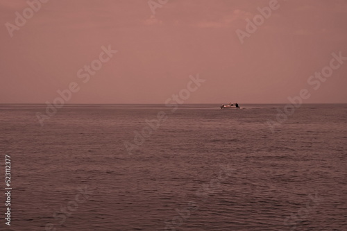 Distant boat sailing on open sea © Vedrana