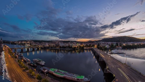 Panoramic view on Ltava river and Prague Hill Petrin aerial timelapse and Jirasek Bridge day to night transition with beautiful colorful sky, Czech Republic. View from top of dancing house. photo