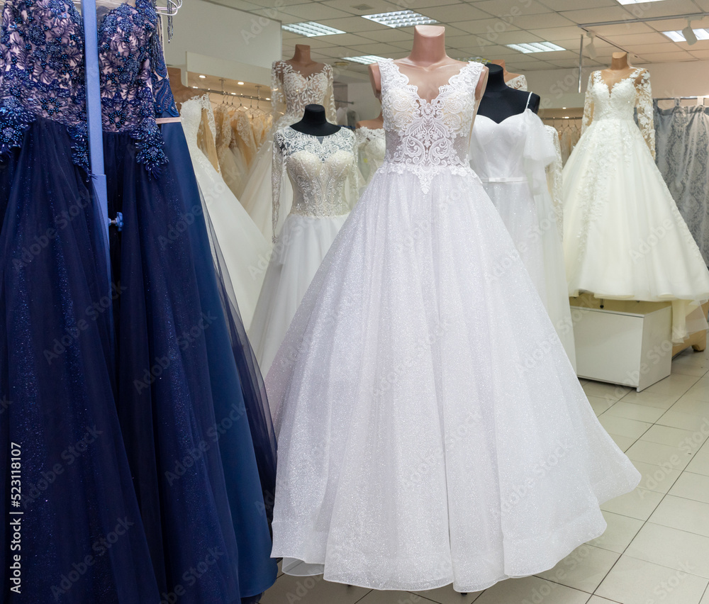 Many different wedding dresses in the bridal shop Many different wedding dresses in the bridal shop