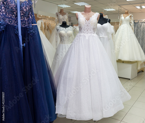 Many different wedding dresses in the bridal shop