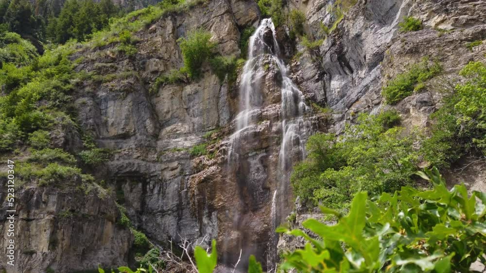 Jib up from bush to reveal waterfall on rocky cliff, Stewart Falls, Provo Utah Jib up from bush to reveal waterfall on rocky cliff, Stewart Falls, Provo Utah