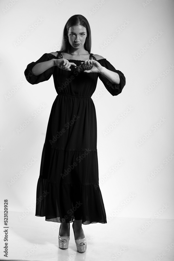 Young woman in dress with a grenade in black and white