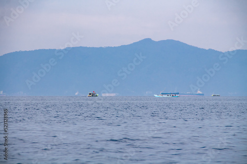 Blue ocean with boats running on island background
