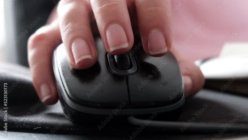 Woman hand working with computer mouse, close up Woman hand working with computer mouse, close up