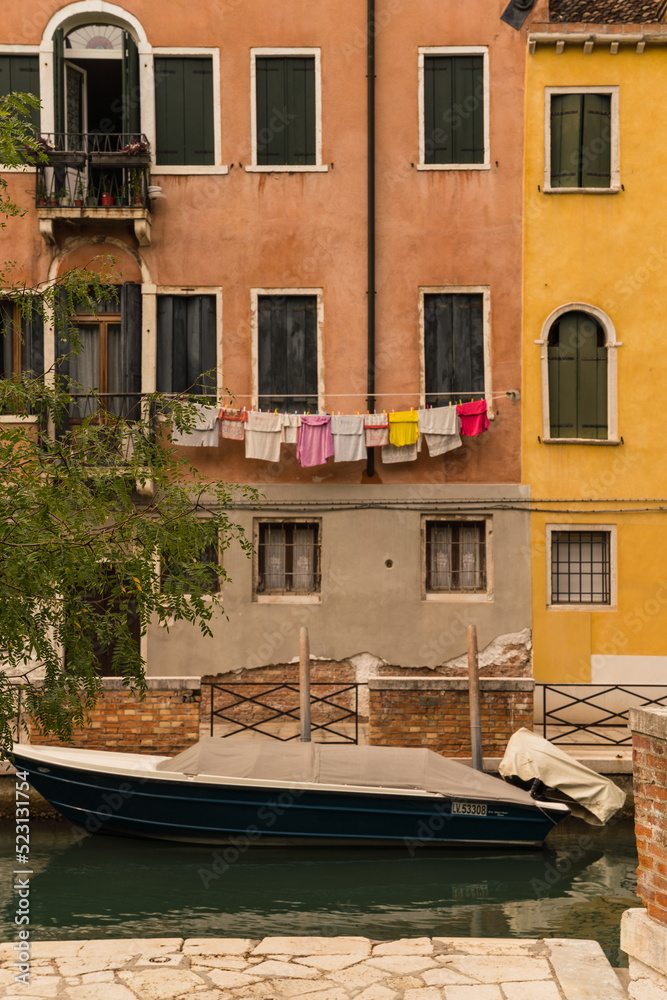 colorful laundry hung to dry outside of a building in Venice, Italy