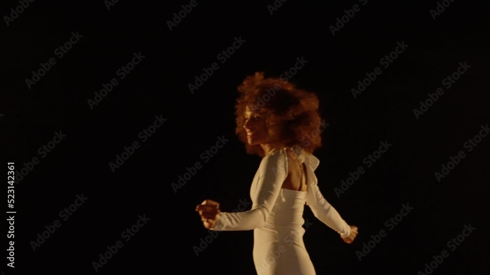 Charming African American Woman Enjoys Music and Dancing Under Shiny Disco Ball Charming African American Woman Enjoys Music and Dancing Under Shiny Disco Ball