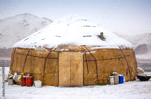 Yurts in winter. National ancient house of the peoples of Kyrgyzstan and Asian countries. national housing. Yurts against the backdrop of snow and highlands. Yurt camp for tourists.