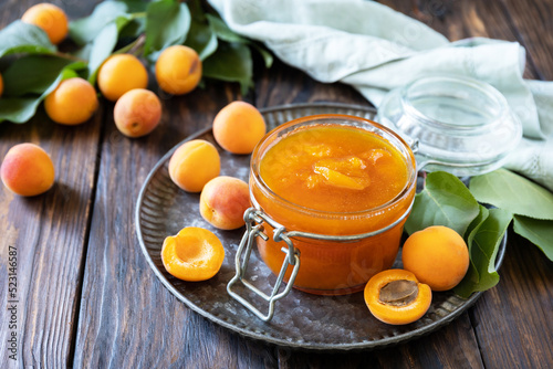 Homemade preservation. Delicious apricots jam or jelly on a rustic wooden table. Copy space.