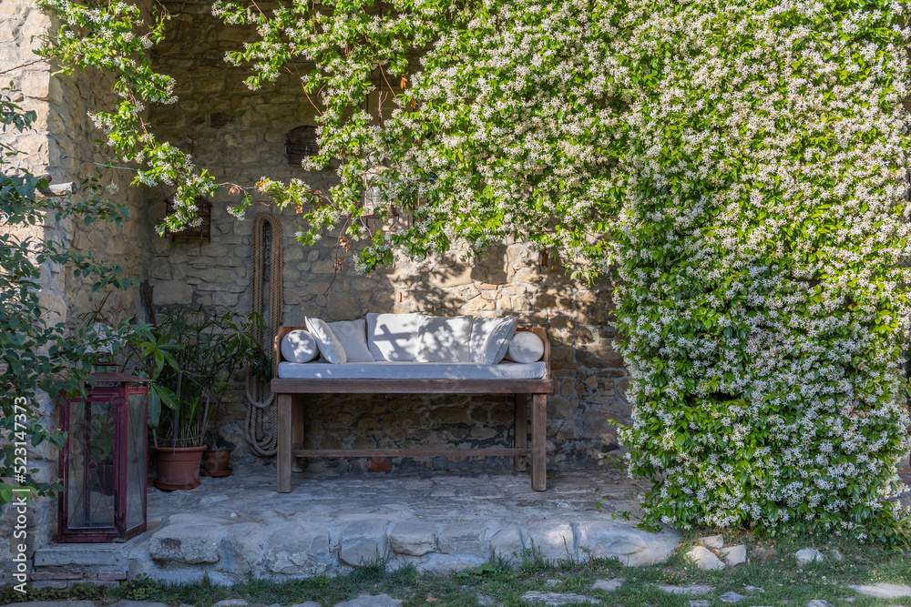 Paradise on earth, a wooden bed on a cobblestone porch in an Italian rustic country house, with rich jasmine plant, natural shade, relaxing spot. Paradise on earth, a wooden bed on a cobblestone porch in an Italian rustic country house, with rich jasmine plant, natural shade, relaxing spot.