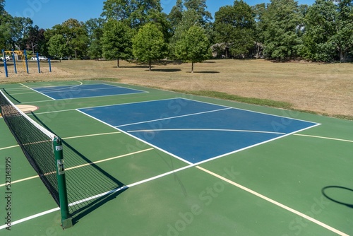 Empty Pickleball court blue and green recreational sport at an outdoor park. © KingmaPhotos