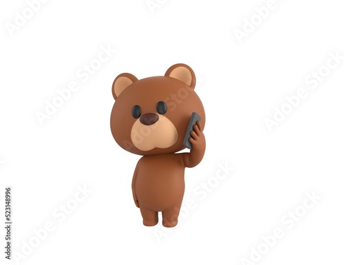 Little Bear character holding smartphone near ear in 3d rendering.